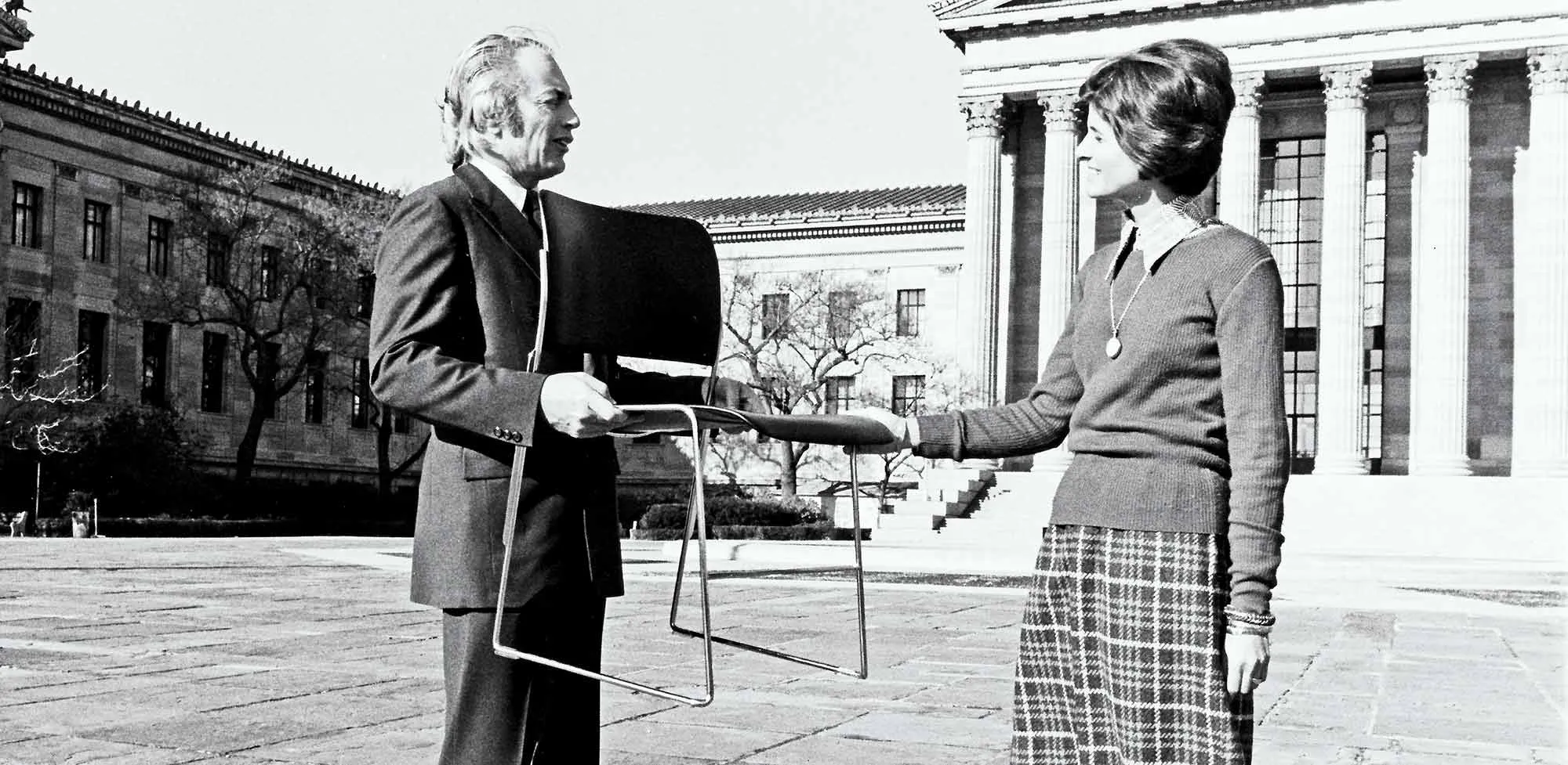 David Rowland holding 40/4 chair Philadelphia Art Museum